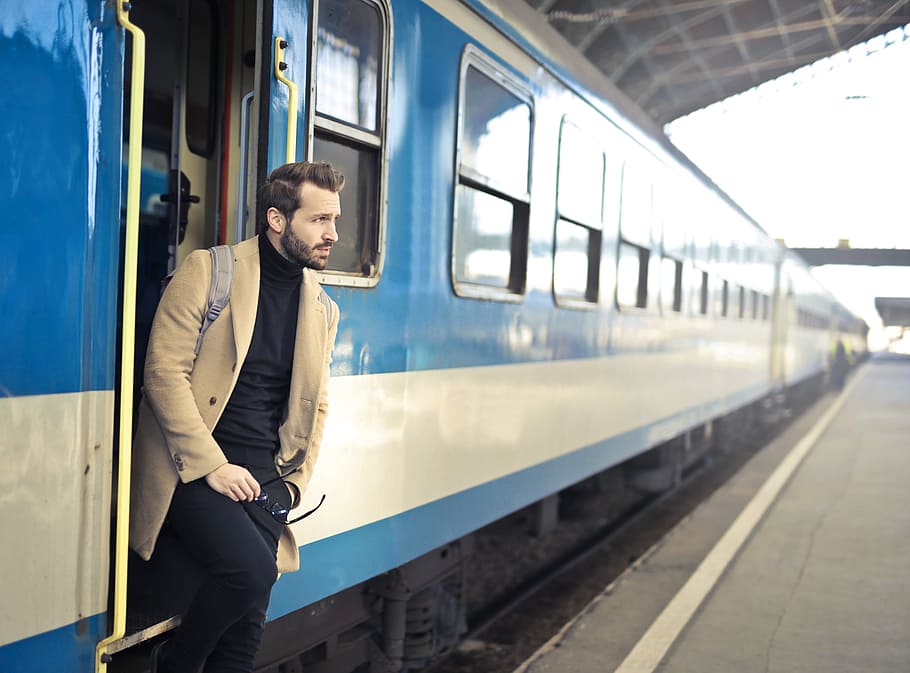 young, adult man, posing, open, train door, railway station, 30-35 years old, adult, arrival, bag