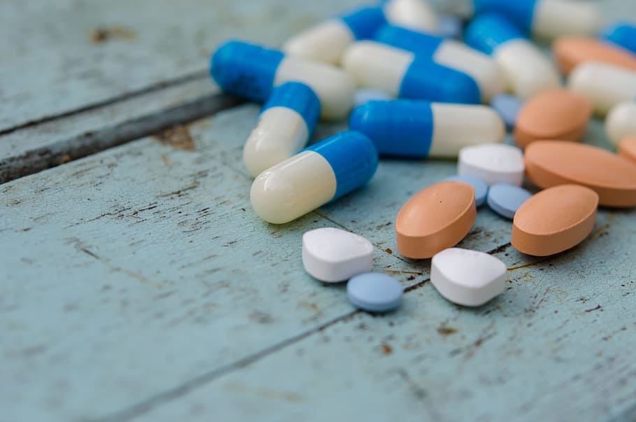 tablets, pills, medicine, wood, table, medical, relief, blue, white, orange