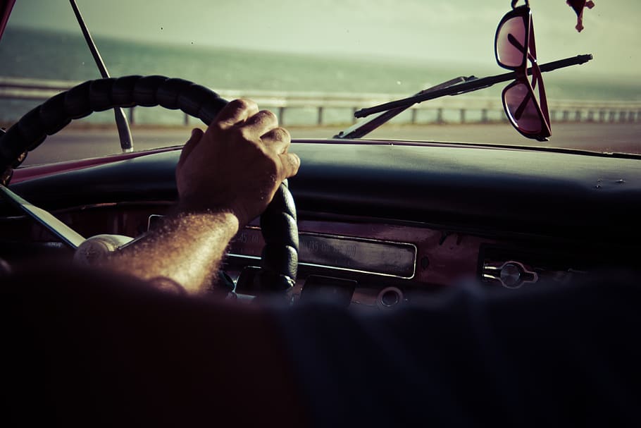 driving, steering wheel, dash, sunglasses, windshield, car, hand, mode of transportation, motor vehicle, transportation
