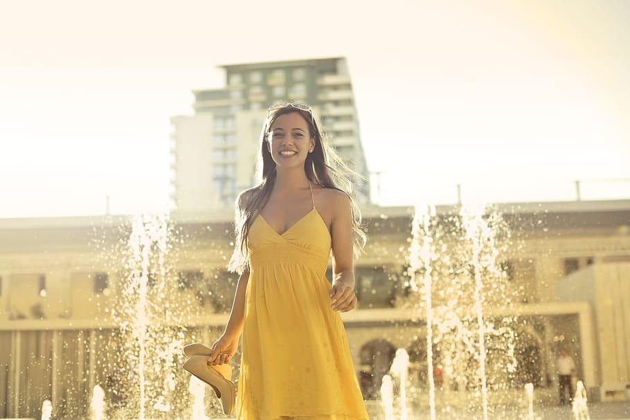beautiful, young, woman, yellow, spaghetti, strap, dress, stands, water fountain, 25-30 years