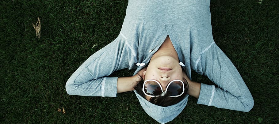 lying down, hoodie, sunglasses, grass, ground, people, one person, relaxation, high angle view, plant