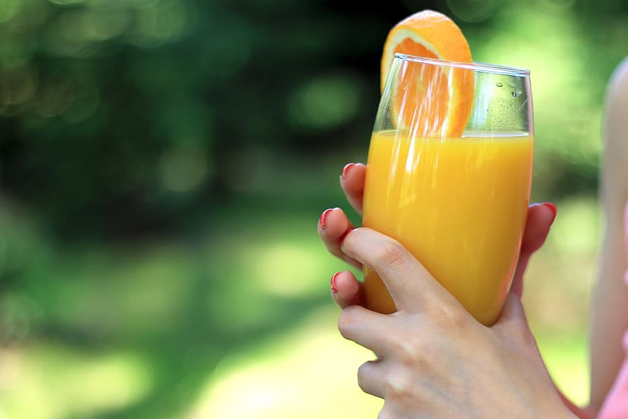 glass, orange, juice, hands, woman, nature, human hand, hand, human body part, one person