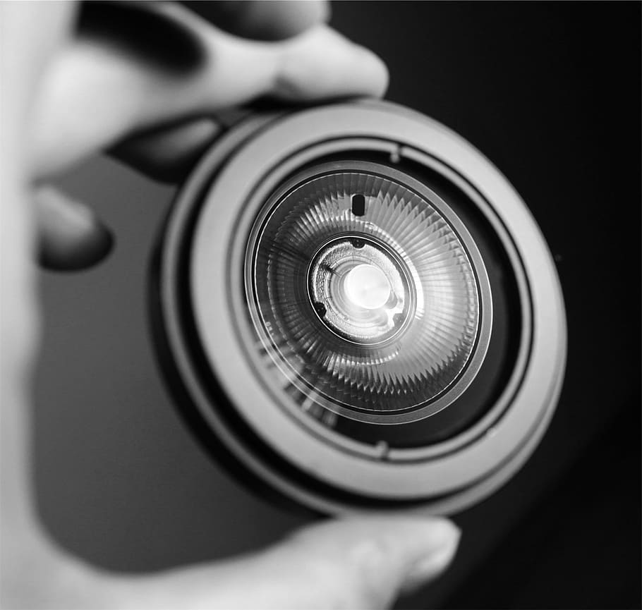light, black and white, lens - optical instrument, technology, photography themes, camera - photographic equipment, photographic equipment, studio shot, close-up, human hand