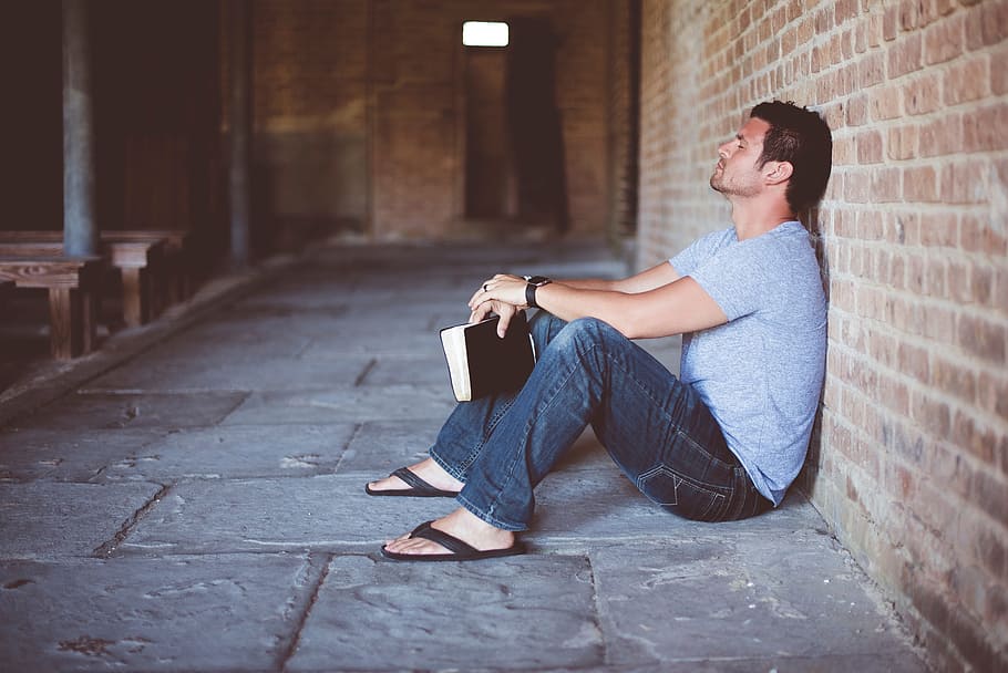 people, man, alone, sitting, wall, book, bible, one person, casual clothing, young adult