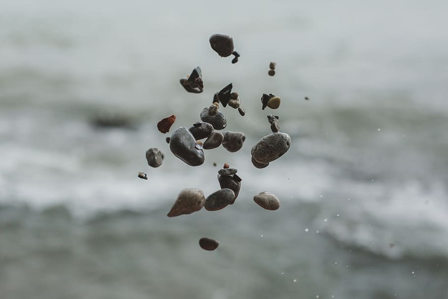 close, pebble stones, floating, air, thrown, blurred, background, ocean, seashore, beach