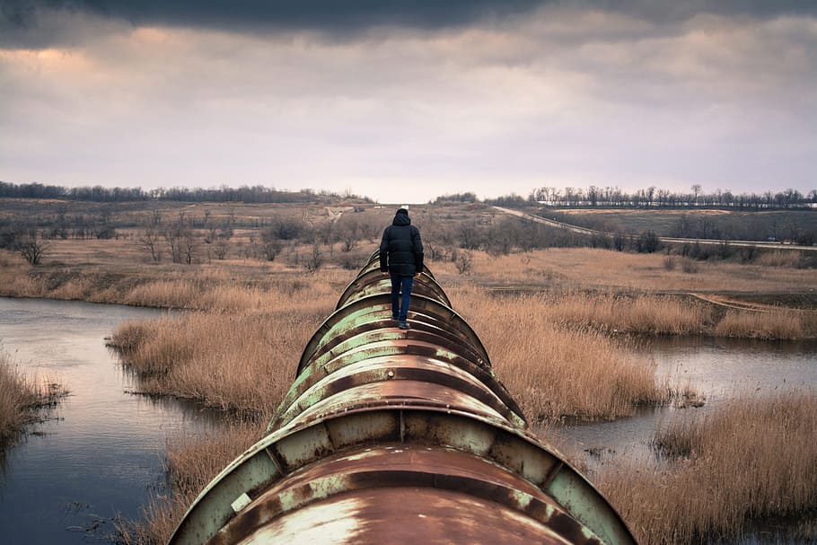 pipe, pipeline, people, man, guy, walking, rural, river, water, reeds