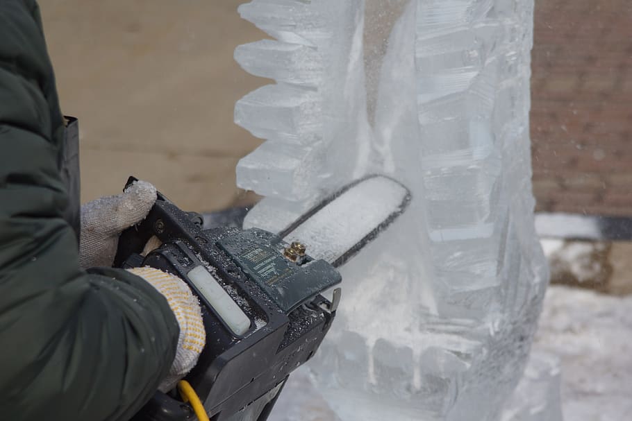 ice sculpting, carving, sawing, wings, day, gun, one person, weapon, focus on foreground, real people