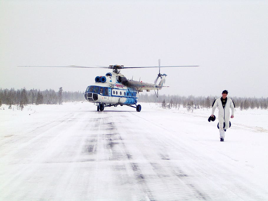 helicopter, man, helipad, landing, airfield, transportation, sky, flying, travel, day