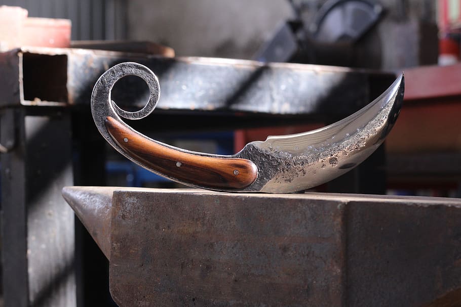 karambit, knife, knives, bladesmith, forge, brut forge, cut, focus on foreground, close-up, workshop