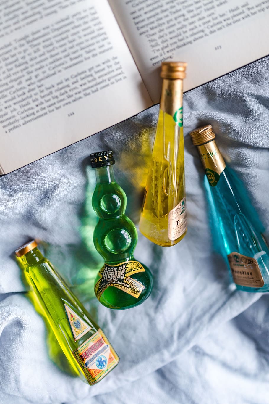 group, colorful, little, bottles, liqueurs, book, drink, read, time, top view