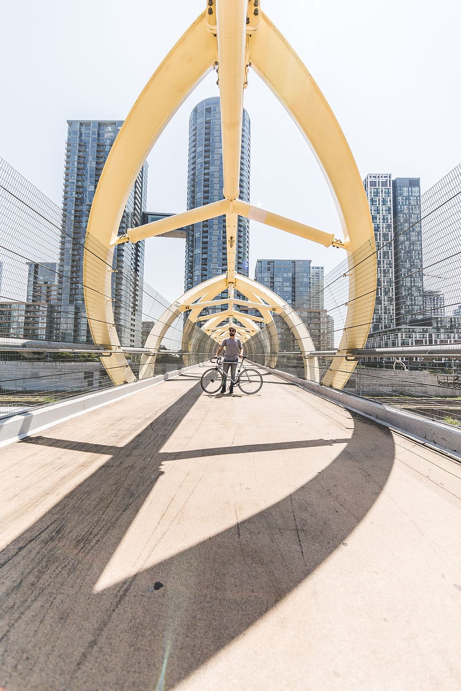ciclista, de pie, bicicleta, moderno, puente, ciudad, peatón, pasarela, carril bici, arquitectura