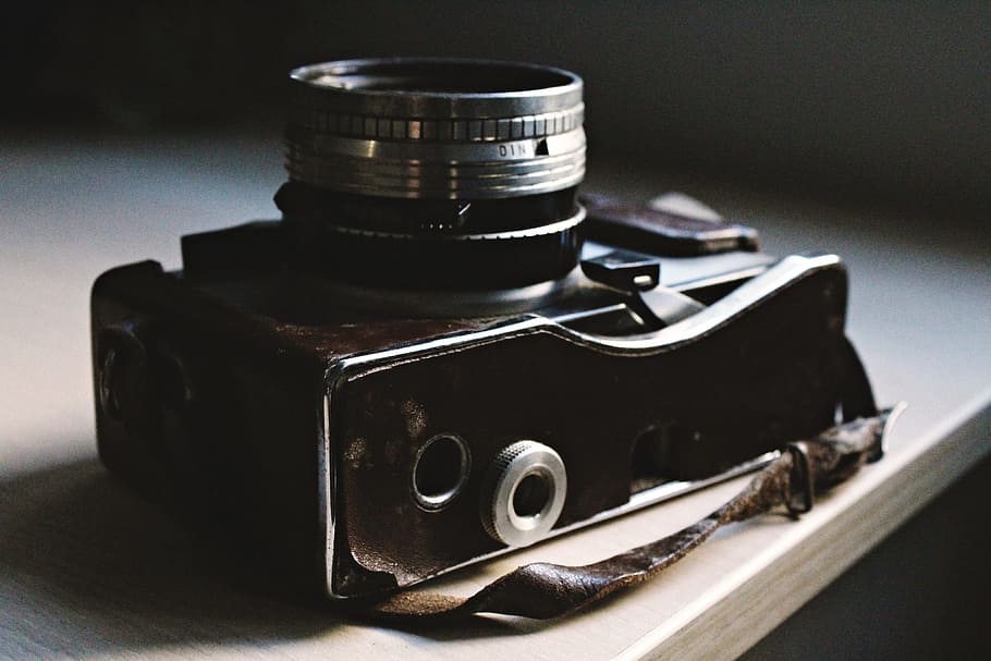 vintage old camera, technology, camera, vintage, indoors, close-up, single object, table, studio shot, focus on foreground