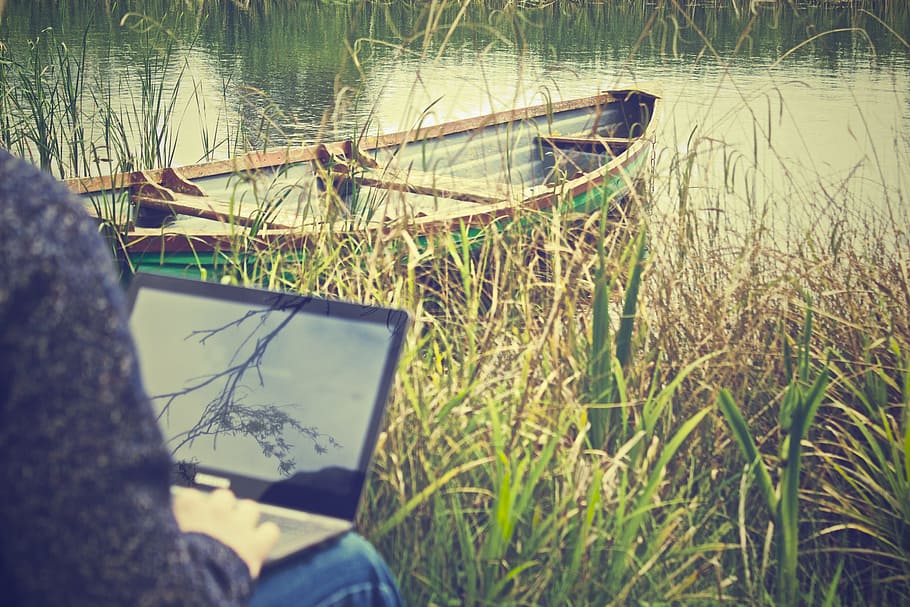 working, outdoors, laptop, typing, grass, river, water, boat, nature, technology