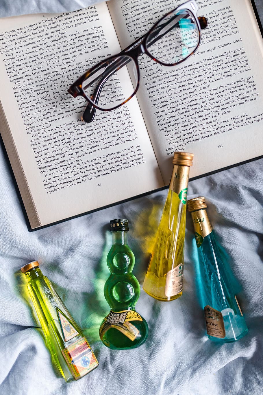 group, colorful, little, bottles, liqueurs, book, drink, read, time, top view
