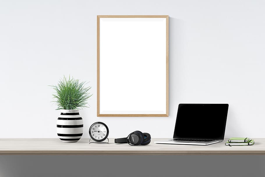 poster, frame, plant, laptop, book, clock, headphone, technology, computer, table