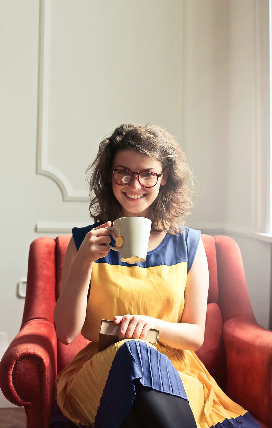 young, woman, wearing, spectacles, holding, enjoying, cup, tea, home, 30-35 years