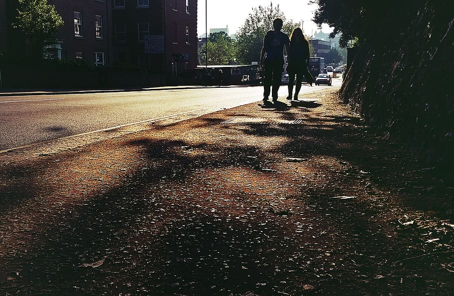 street, people, couple, road, silhouette, shadows, sunlight, real people, lifestyles, rear view