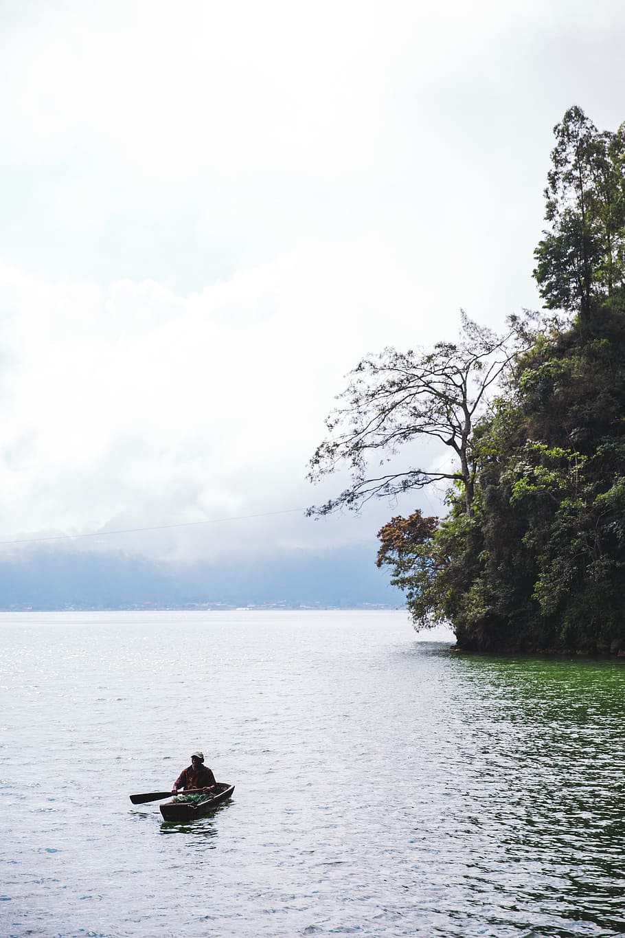 man, canoe, cliffside lake, fishing, floating, green, lake, mountain, reflection, rock