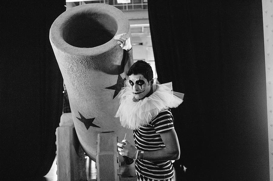 black and white, people, man, clown, costume, indoors, portrait, standing, looking at camera, celebration