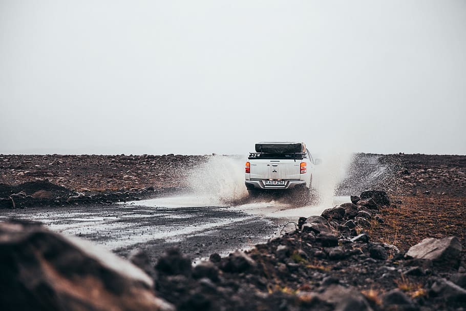 rear, view, white, pick-up, truck puddle, splashing, muddy, road, drive, driving