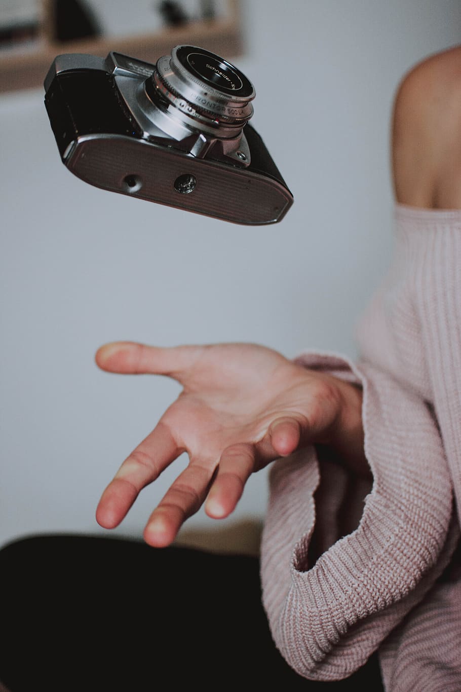 camera, levitation, flying, hand, throw, float, human hand, indoors, human body part, real people
