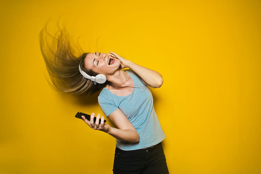 excited, woman dancing, listening, headphones, smart, phone, hair, moving, isolated, background