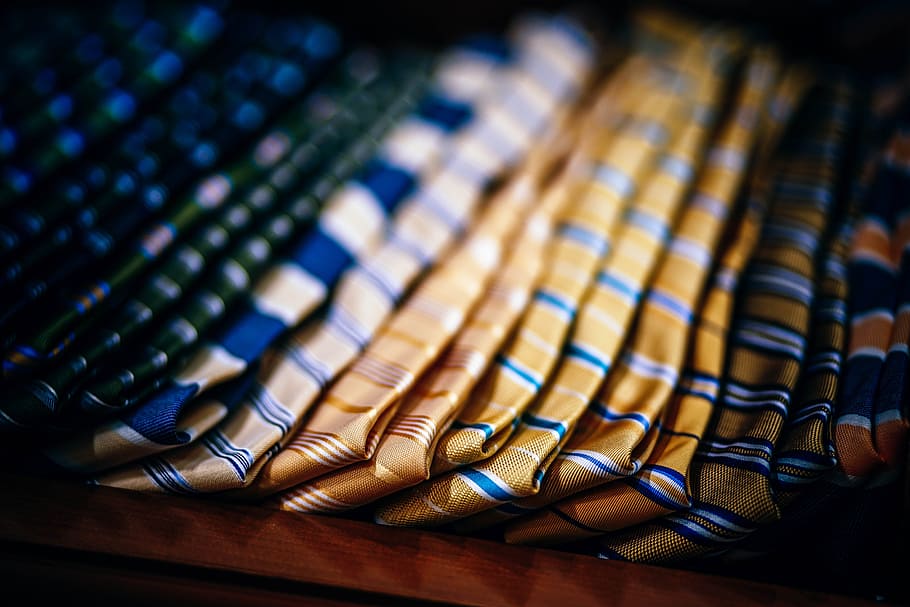 luxurious ties, indoors, close-up, large group of objects, selective focus, choice, in a row, focus on foreground, variation, abundance