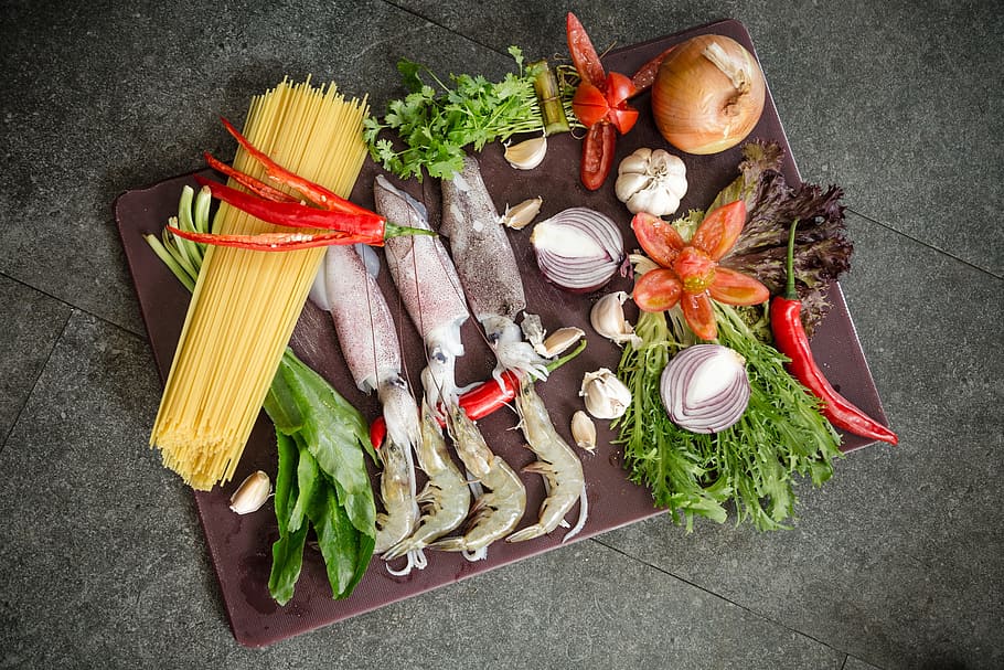 food, platter, fish, squid, ingredients, vegtables, wood, table, spaghetti, onion