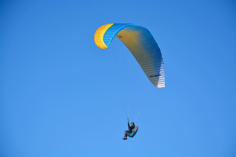 paragliding, paraglider, wing ozone rush 5, sail blue orange yellow, flying site, aircraft, adventure, entertainment, sails wings multi-color, blue sky