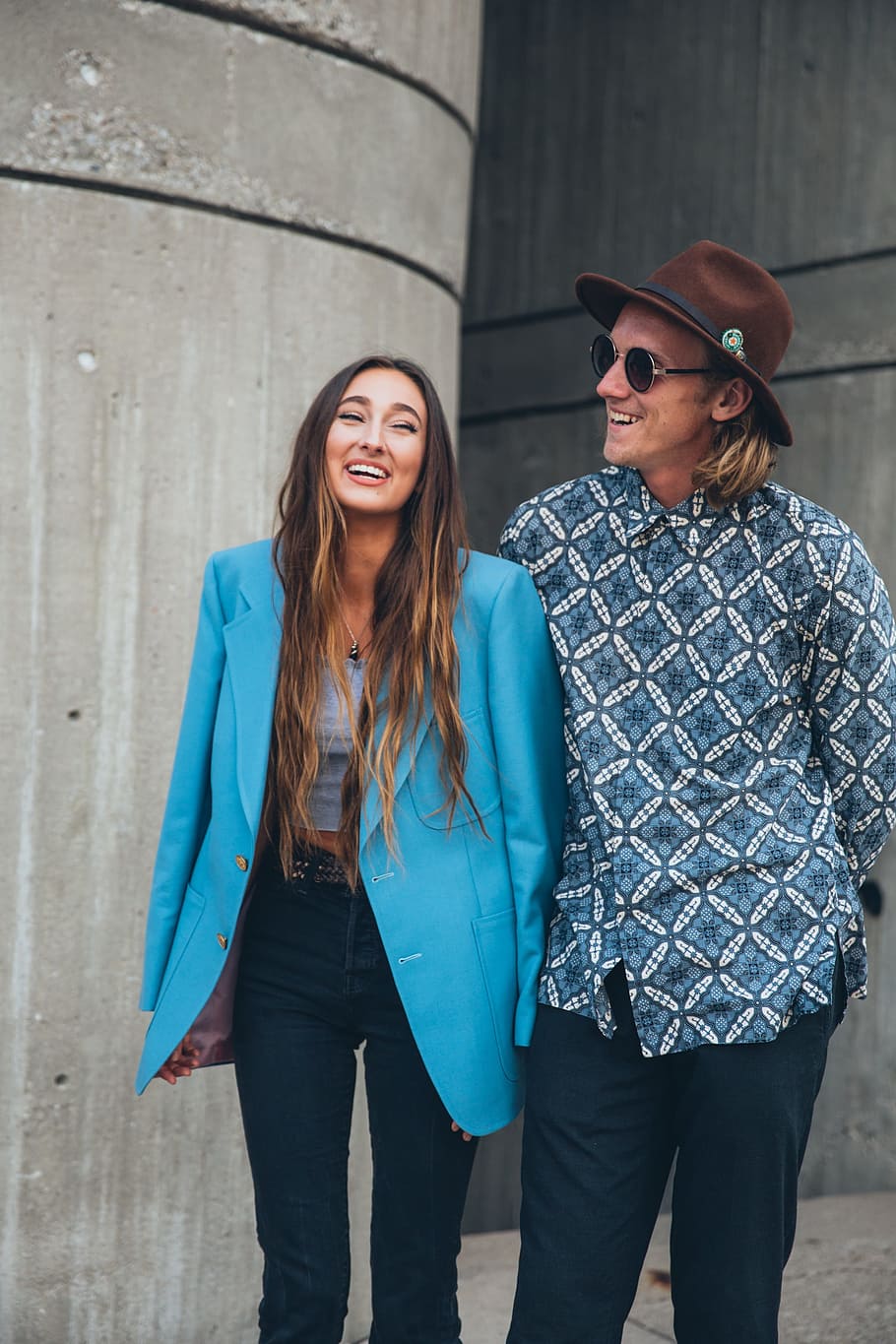 caucasian couple, laughing, 25 to 30 year old, Happy, Hat, Outdoors, Portrait, Sidewalk, Smiling, Trousers