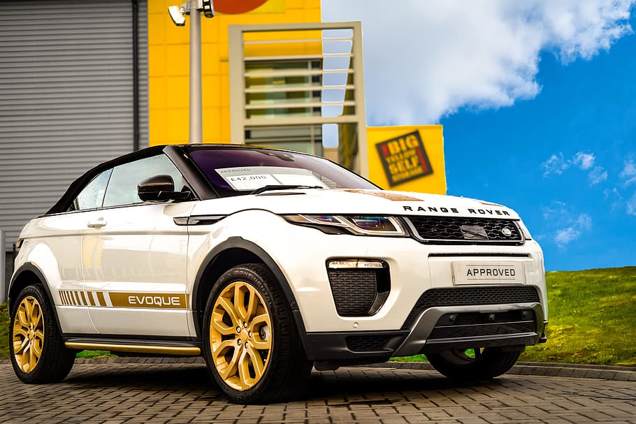 range rover evoque convertible, convertible, suv, showroom, yellow building, mode of transportation, transportation, car, motor vehicle, land vehicle