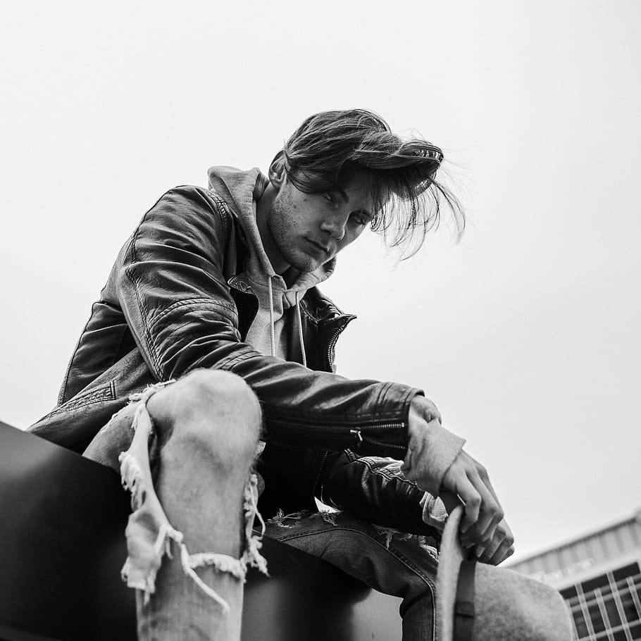 man, guy, male, black and white, ripped, jeans, sky, sitting, knee, jacket
