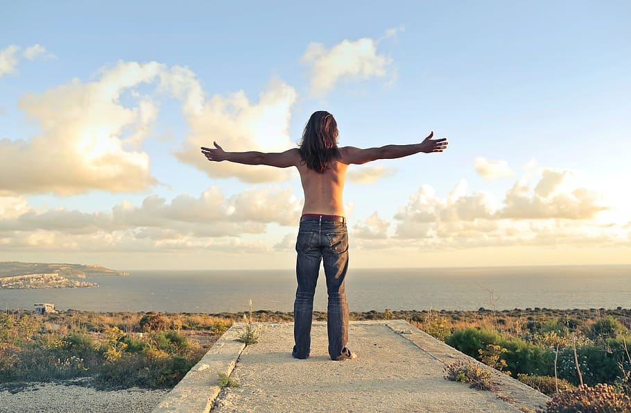 man, wearing, denim jeans, standing, seashore, arms stertched, adult, back, green, horizon