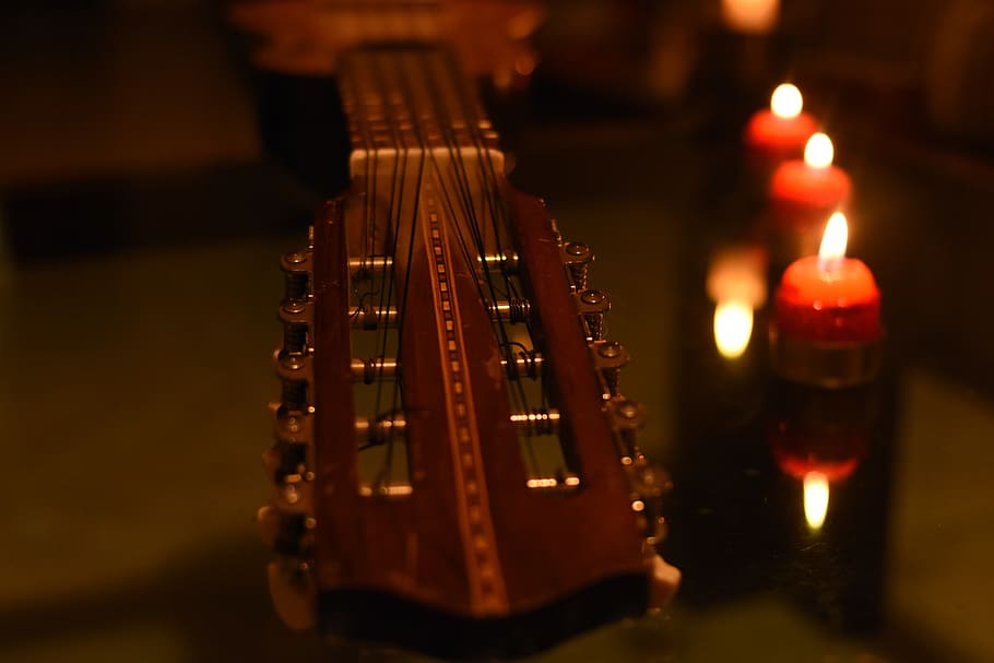 charango, music, light of a candle, decoration, musical instrument, string instrument, arts culture and entertainment, musical equipment, indoors, close-up