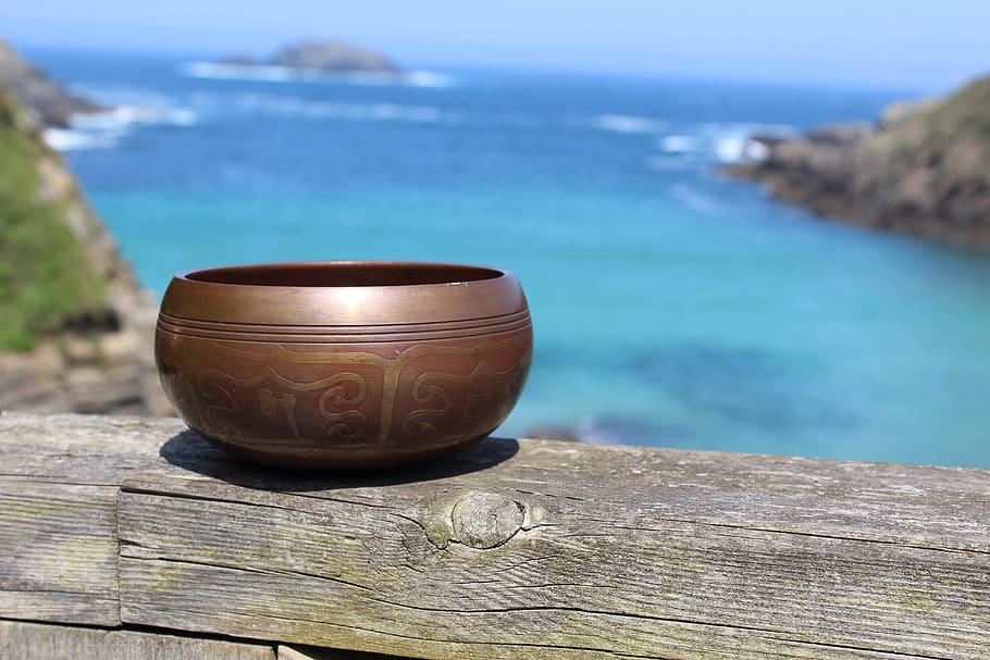 tibetan, singing bowl, meditation, relaxation, wellness, nature, outdoors beach, water, wood - material, focus on foreground