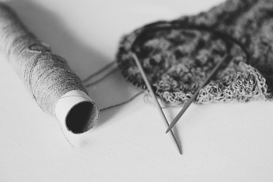 knitting, yarn, black and white, close-up, indoors, art and craft, human body part, thread, selective focus, textile