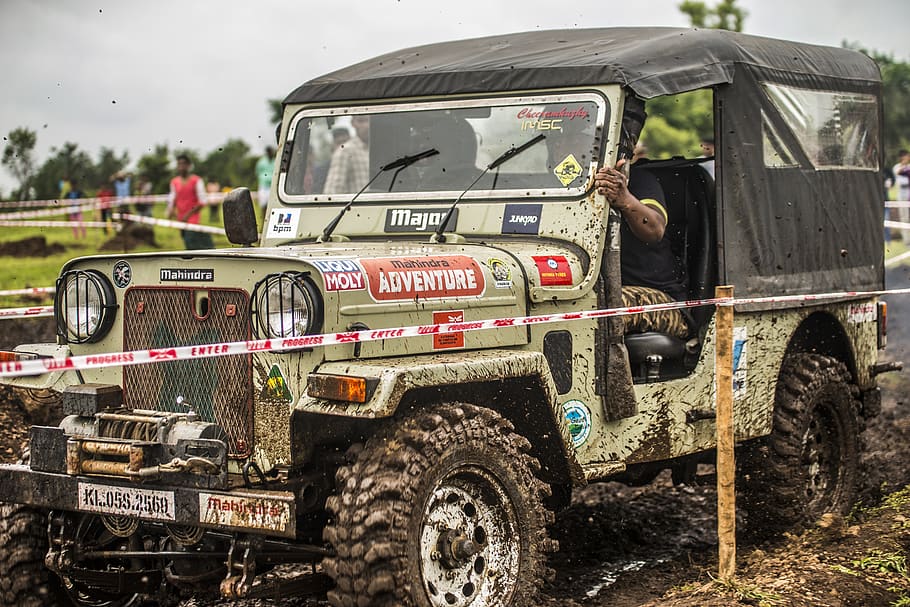 activity, adventure, armed forces, blurred motion, brown, car, carrying, commercial land vehicle, competition, contest