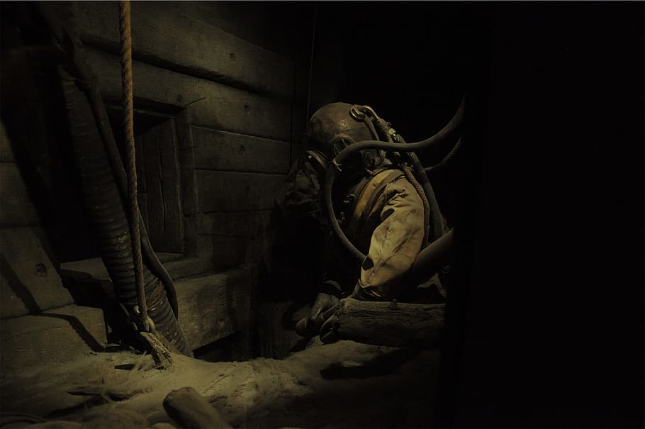 hole, ropes, hoses, helmet, protective suit, indoors, architecture, night, sculpture, military