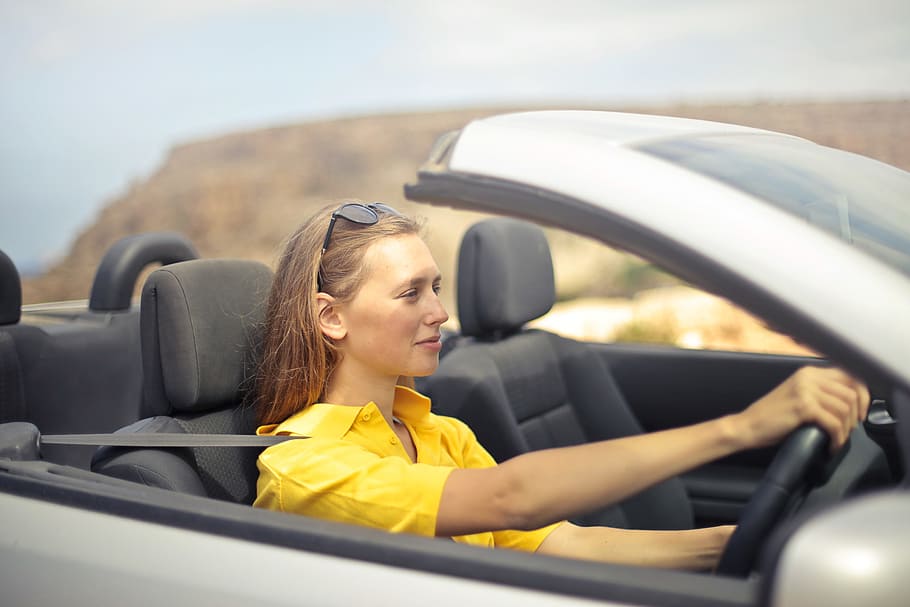 young, woman, wearing, half-sleeved, yellow, shirt, driving, convertible, silver car, Drive