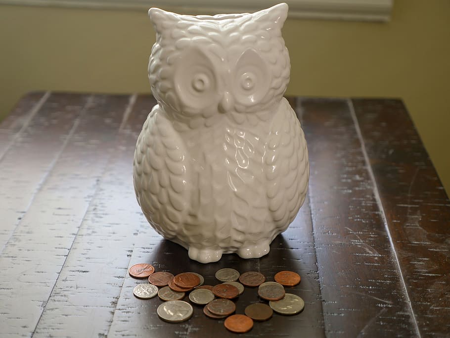owl, shaped, ceramic, piggybank, assortment, coins, front, it., sitting, wood desk