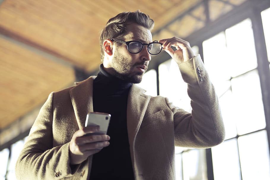 young, adult man, removing, right hand, holding, cellphone, left, 30-35 years old, Glasses, Stubble