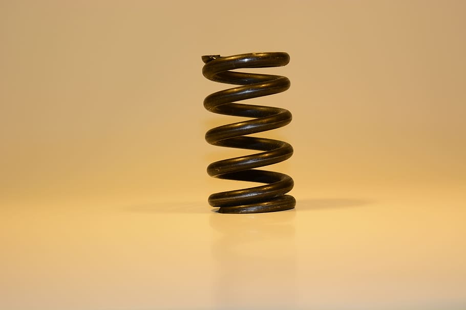 steel, metal, spring, spiral, studio shot, indoors, colored background, reflection, simplicity, copy space