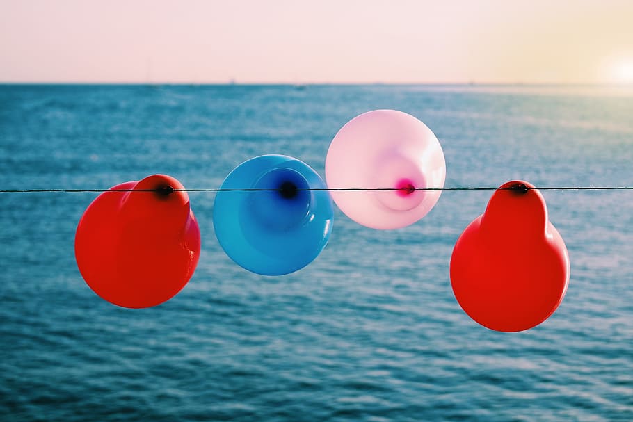 balloon, colorful, red, blue, pink, wire, ocean, sea, water, horizon