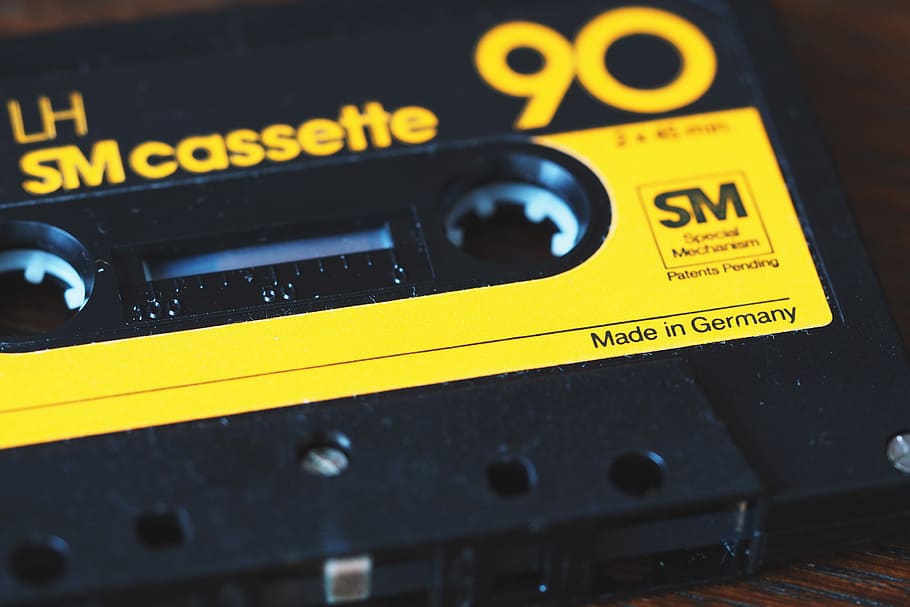cassette tape, technology, tech, yellow, close-up, communication, retro styled, text, black color, indoors