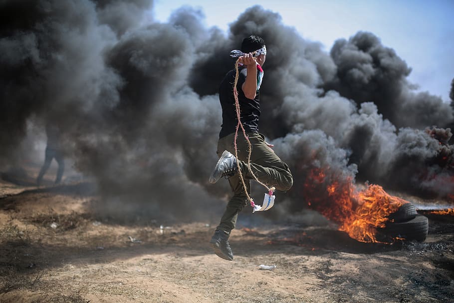 gaza, strip, palestine, smoke - physical structure, one person, full length, motion, burning, young adult, clothing