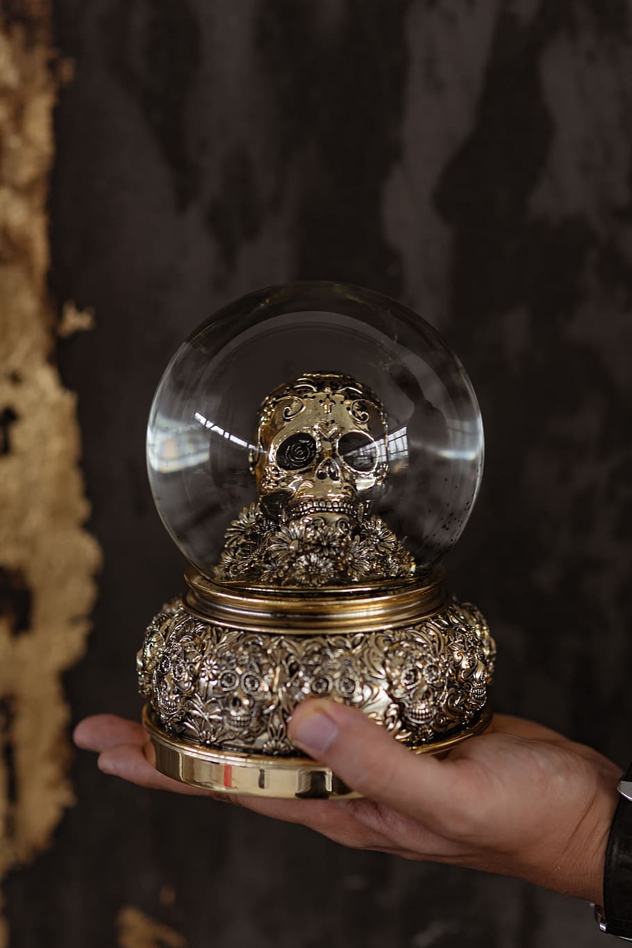 skull snow globe, gold, golden, black, decoration, skull, halloween, spooky, snow globe, human hand