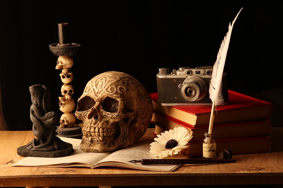 memento mori, skull, still life, candle, black background, studio shot, indoors, table, publication, book